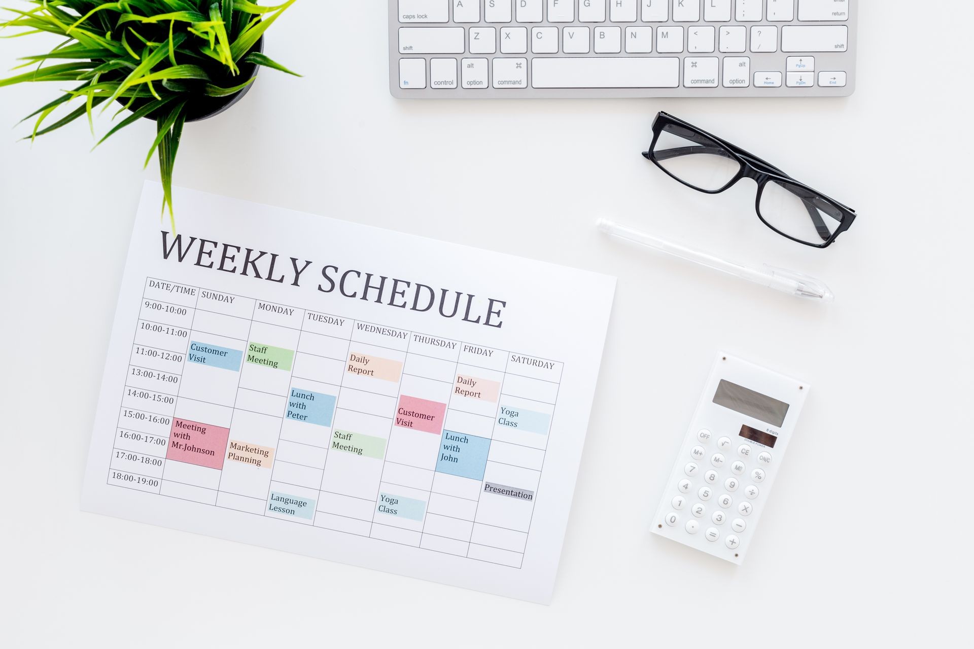 Weekly schedule of manager, office worker, pr specialist or marketing expert. Table with multicolored blocks on white office desk with computer, glasses, calculator top view